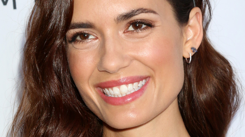 Torrey DeVitto smiles