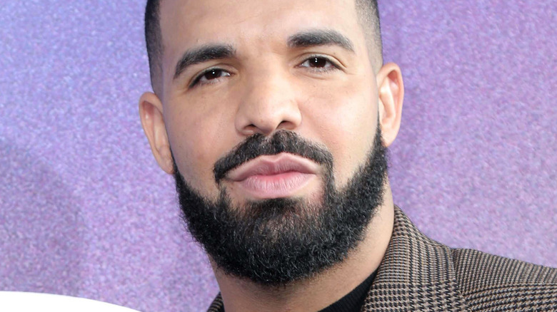 Drake on the red carpet with serious expression