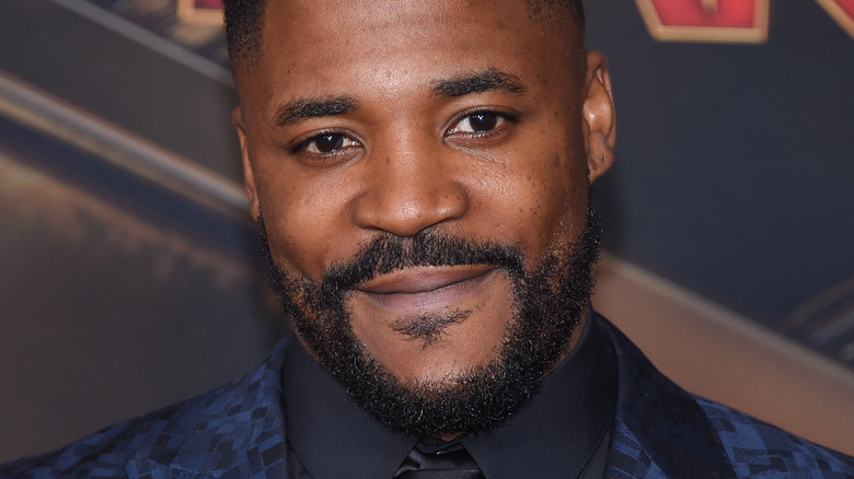 Duane Henry smiles on the red carpet