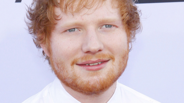 Ed Sheeran smiling and looking to the side