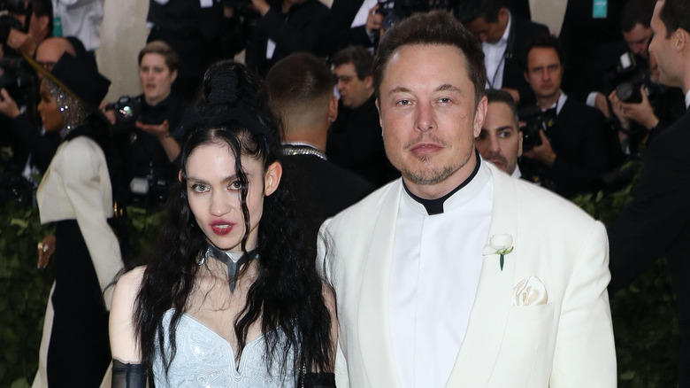 Grimes [posing with Elon Musk