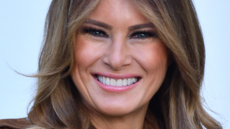 Melania Trump smiling and looking at camera