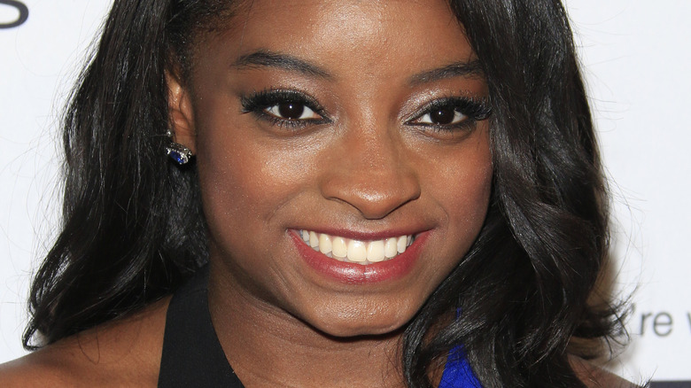 Simone Biles smiling on the red carpet