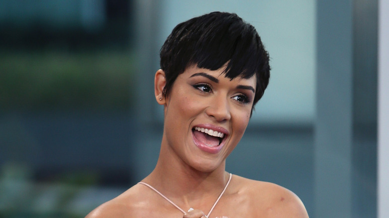 Grace Byers sitting in a chair