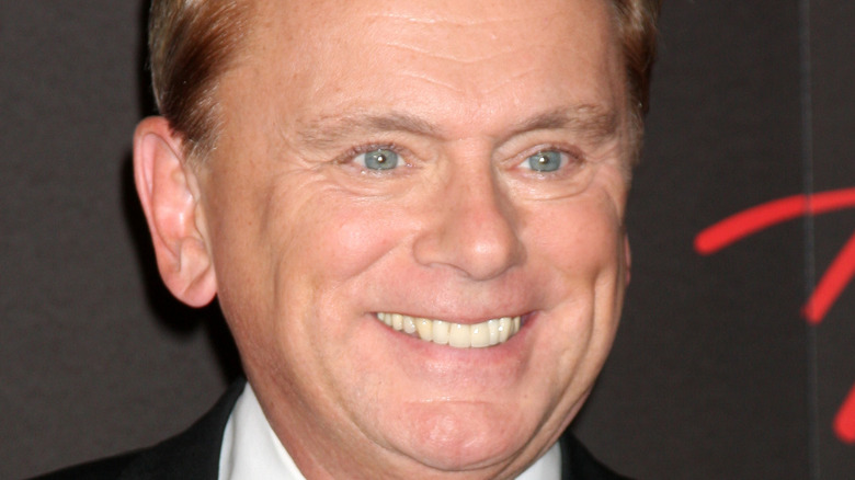 Pat Sajak smiles at an event