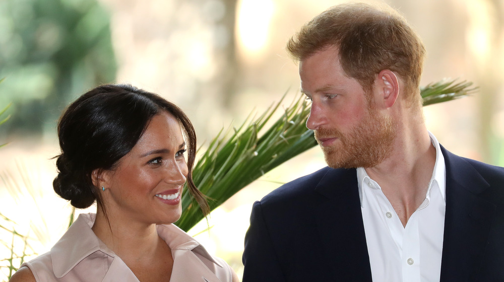 Meghan Markle smiles at Prince Harry