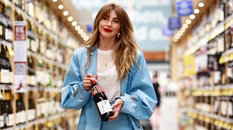 Julianne Hough holds a bottle of wine