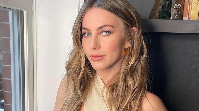 Julianne Hough takes a photo by a window.