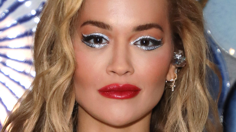 Rita Ora silver eyeliner red lip long blond hair p