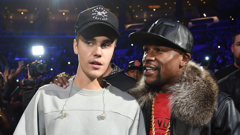 Justin Bieber being hugged by Floyd Mayweather