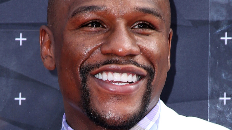 Floyd Mayweather smiles at an event
