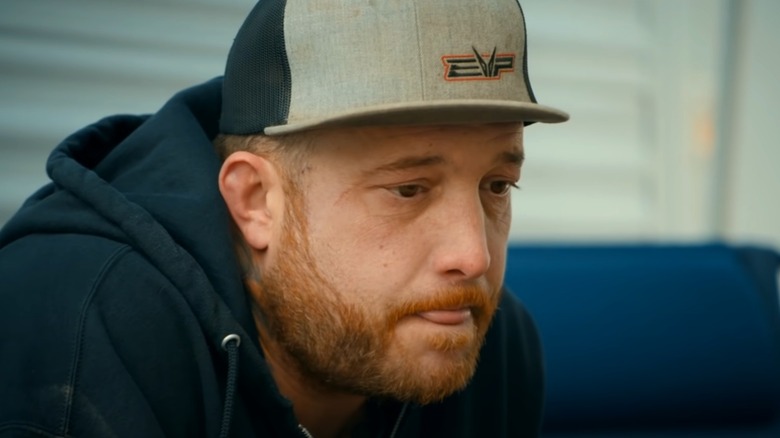 Still of Rick Ness in a baseball cap