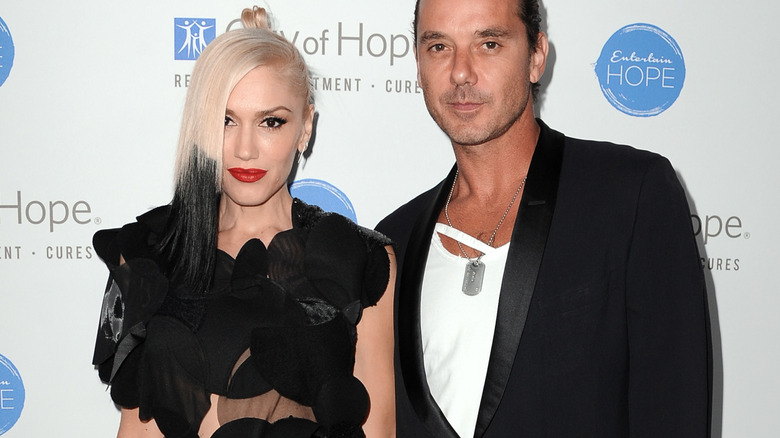 Gwen Stefani and Gavin Rossdale posing together with neutral expressions, both wearing black outfits