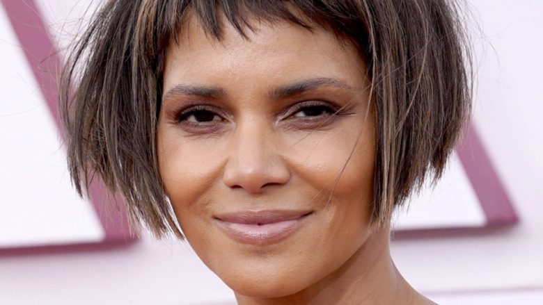 Halle Berry in a short bob haircut with bangs, smiling 