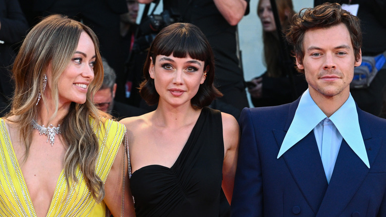 Olivia Wilde, Sydney Chandler, and Harry Styles attend the "Don't Worry Darling" red carpet at the 79th Venice International Film Festival