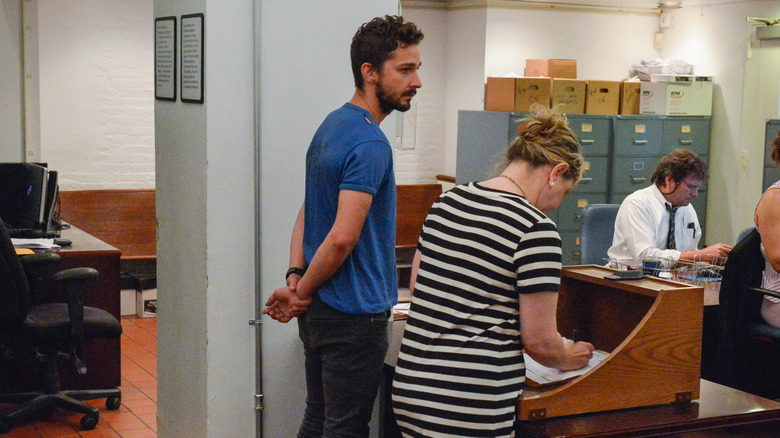 Shia LaBeouf standing in police station