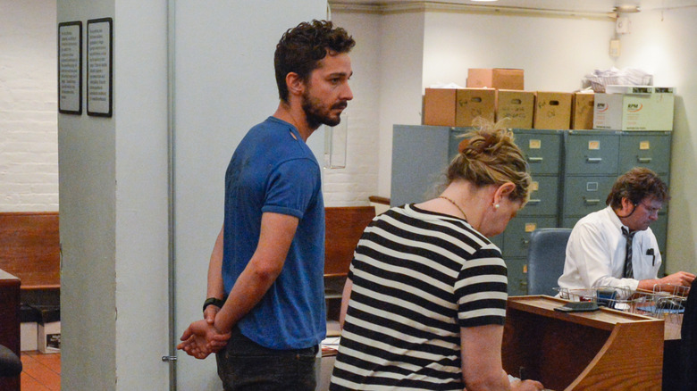Shia LaBeouf standing in police station
