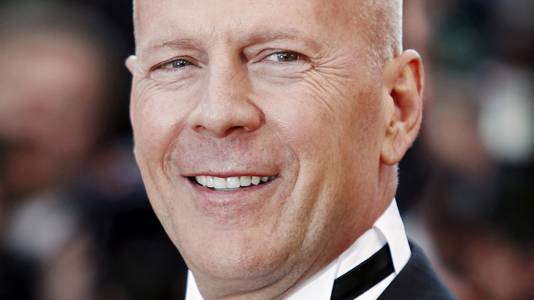 Bruce Willis smiles on the red carpet