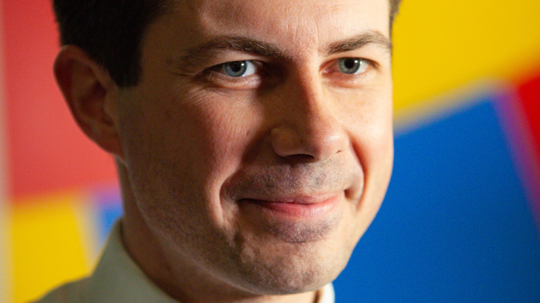Pete Buttigieg in front of colorful background