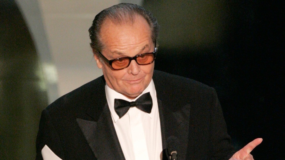 Jack Nicholson in front of microphone, pointing
