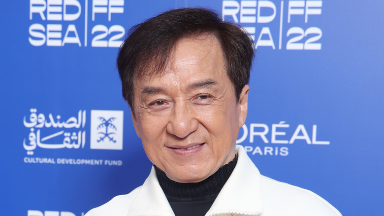 Jackie Chan wearing a white top
