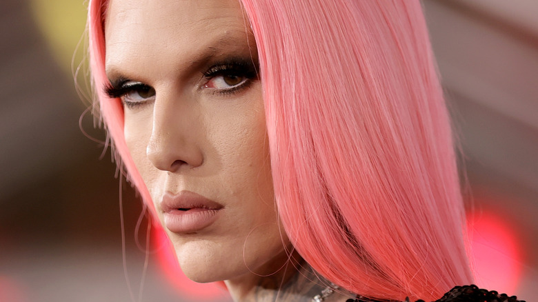 Jeffree Star poses on the red carpet with pink hair