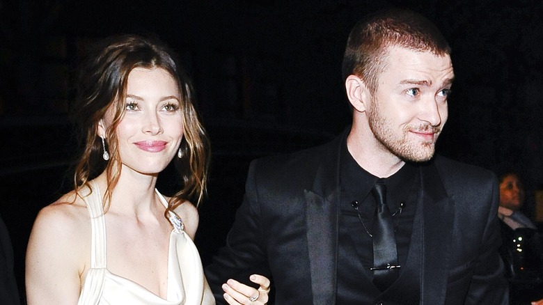 Jessica Biel and Justin Timberlake smile while walking arm in arm