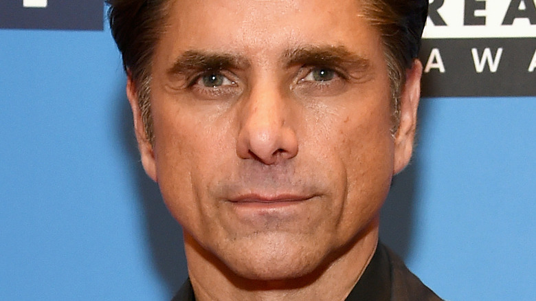 John Stamos staring straight ahead pursed lips