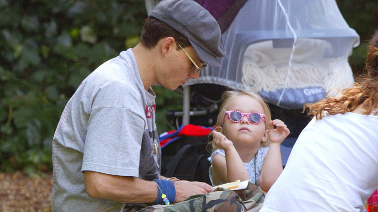Johnny Depp and young Lily-Rose Depp at a park
