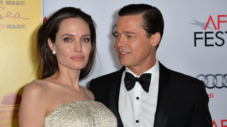 Angelina Jolie and Brad Pitt posing