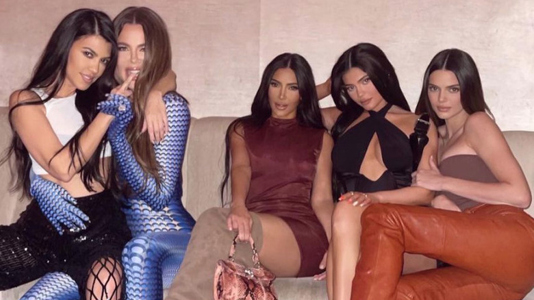 Kourtney, Khloe, and Kim Kardashian sitting with Kylie and Kendall Jenner