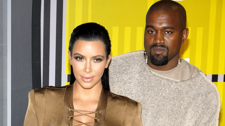 Kim Kardashian and Kanye West pose 