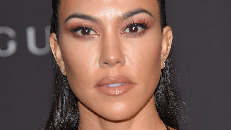 Kourtney Kardashian with serious expression on the red carpet