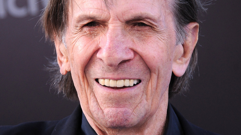 Leonard Nimoy smiles in a black outfit