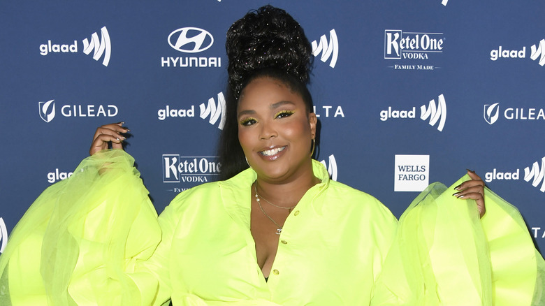 Lizzo wearing a neon green dress