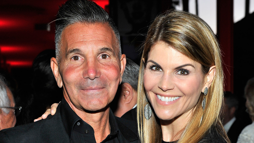 Mossimo Giannulli  and Lori Loughlin pose at a party