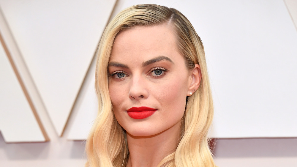 Margot Robbie with a serious expression