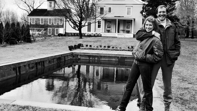 Young Martha and Andy Stewart posing in front of their home
