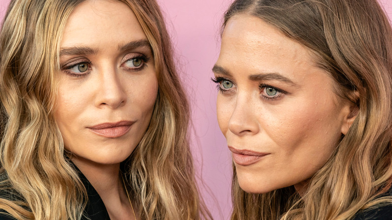 Mary-Kate and Ashley Olsen posing