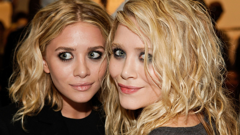 Mary-Kate and Ashley Olsen posing
