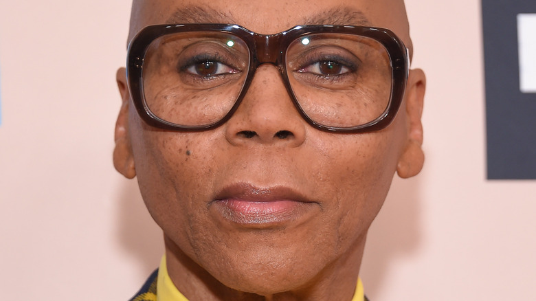 RuPaul wears brown rimmed glasses