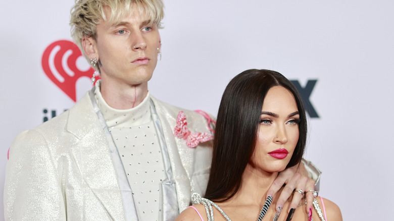 Megan Fox in pink jumpsuit with Machine Gun Kelly