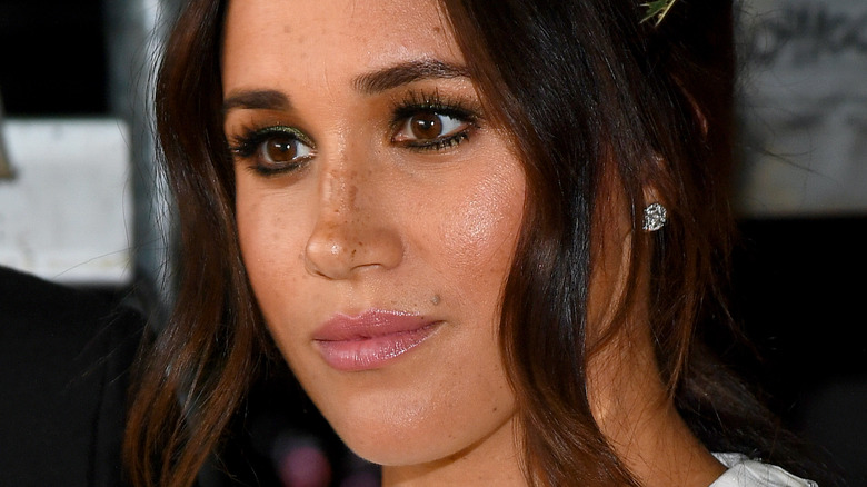 Meghan Markle with a neutral expression