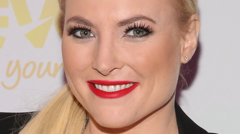 Meghan McCain smiles in red lipstick.