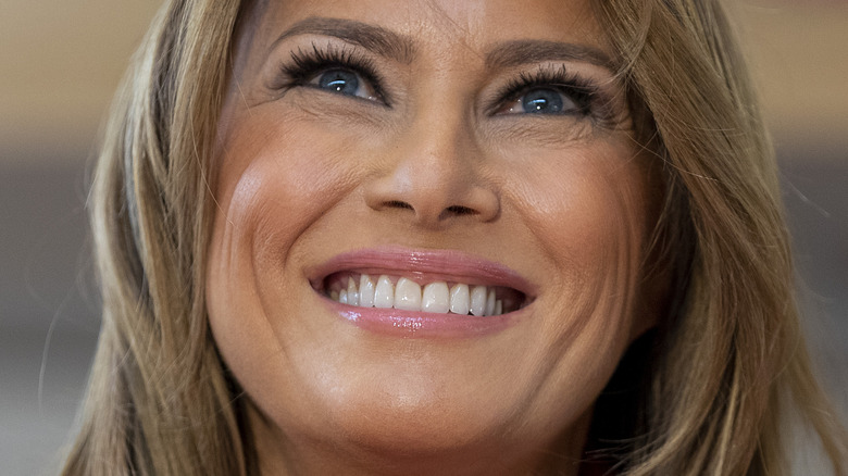Melania Trump smiles looking up