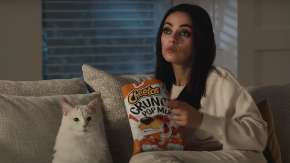 Mila Kunis in Cheetos commercial with a cat