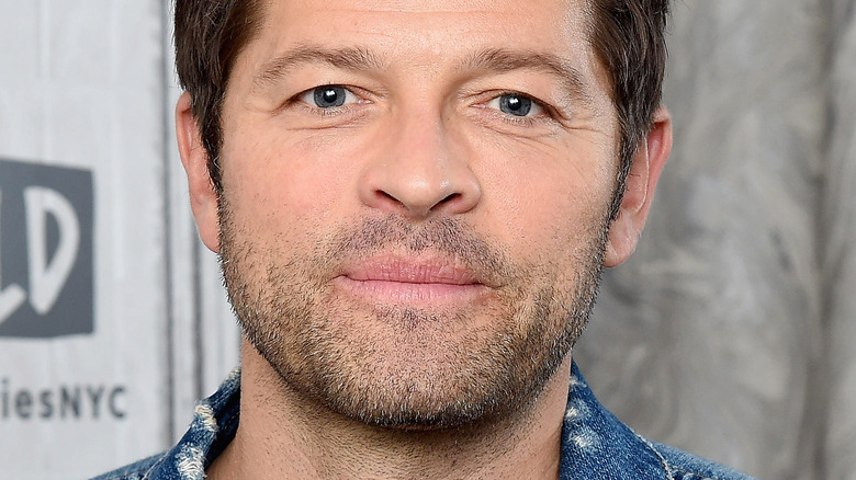 MIsha Collins with denim jacket and serious expression