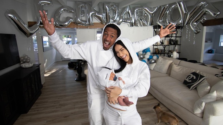 Nick Cannon and Bre Tiesi smiling with their kid