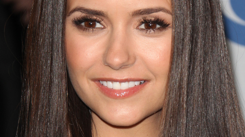 Nina Dobrev smiles