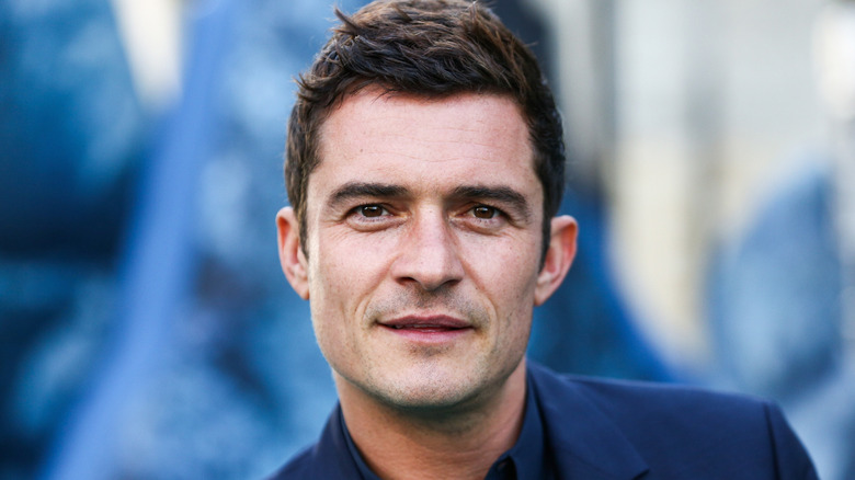 Orlando Bloom blue suit looking at camera